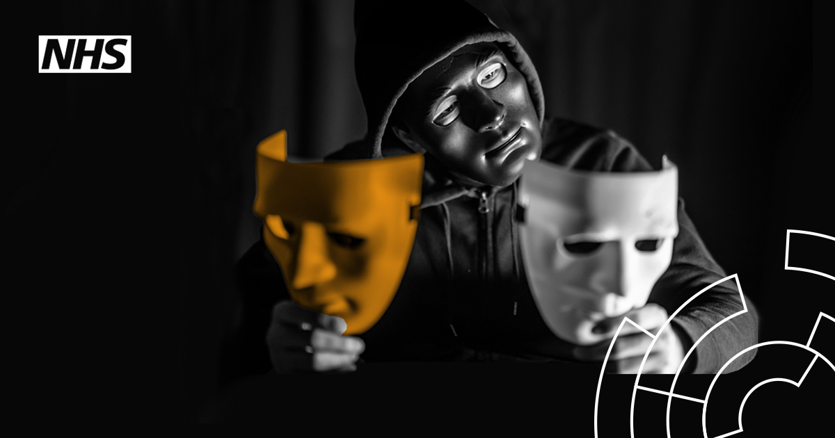 Image showing a hooded person wearing a mask holding up and looking at two diffent masks