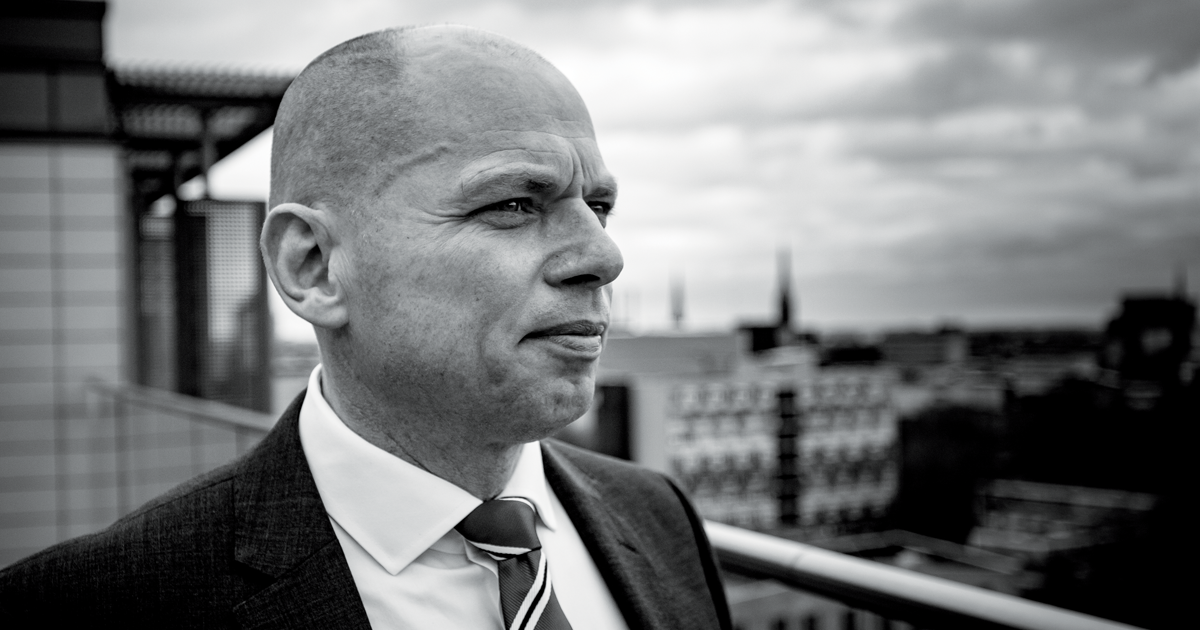 Image of Alex Rothwell CEO of the NHSCFA looking out over a city scape 