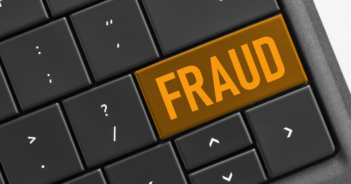 Image showing part of a keyboad with the return key highlighted in orange and displaying the word fraud