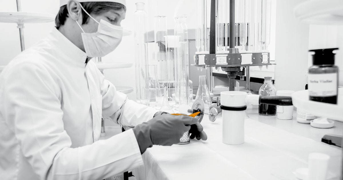 Image of a lab worker working whilst wearing protective equipment