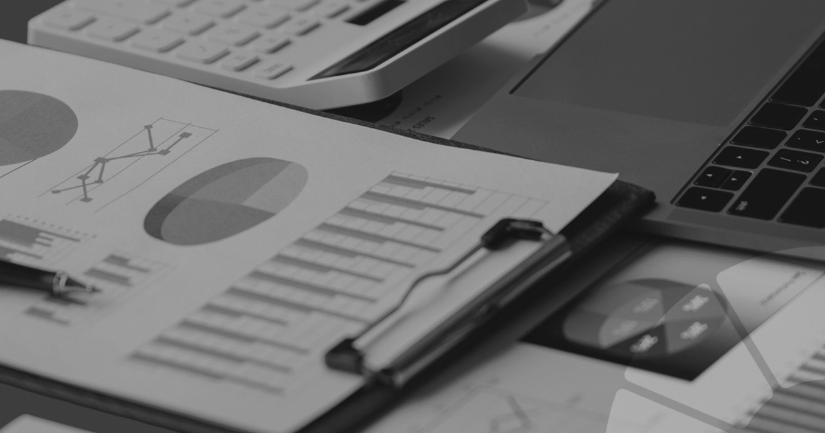 Image of charts and graphs, next toa laptop keyboard and a calculator