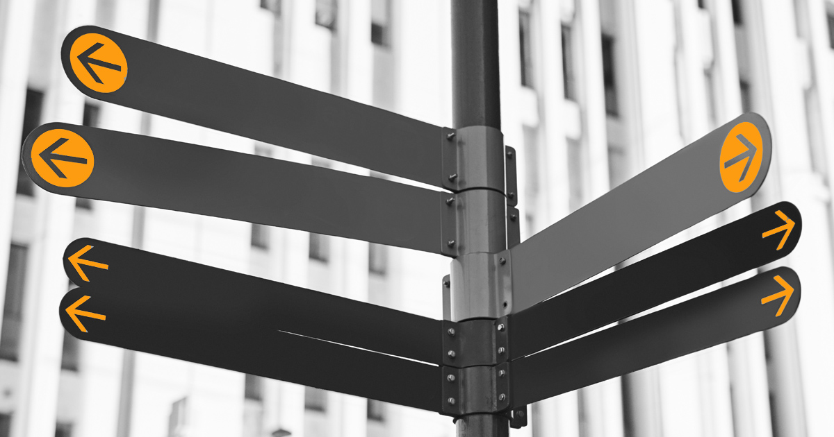 Image showing a blank sign post pointing in many different directions each with an  orange arrow