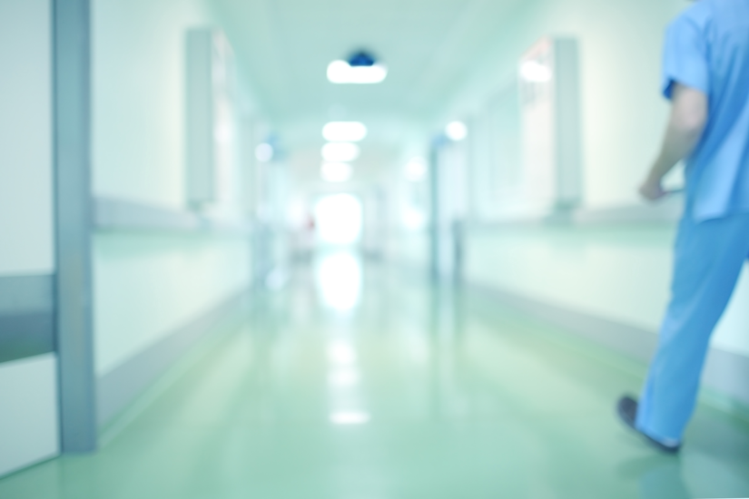 Nurse walking down a hospital corridor.