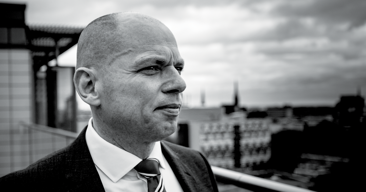 Image of Alex Rothwell CEO of the NHSCFA looking out over a city scape 