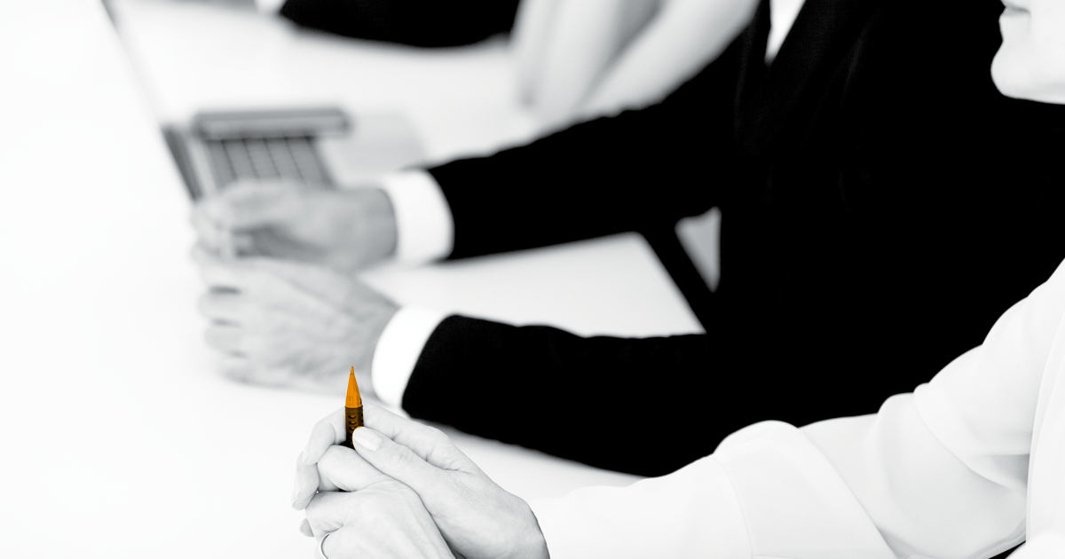 Image of faceless persons sitting in a meeting