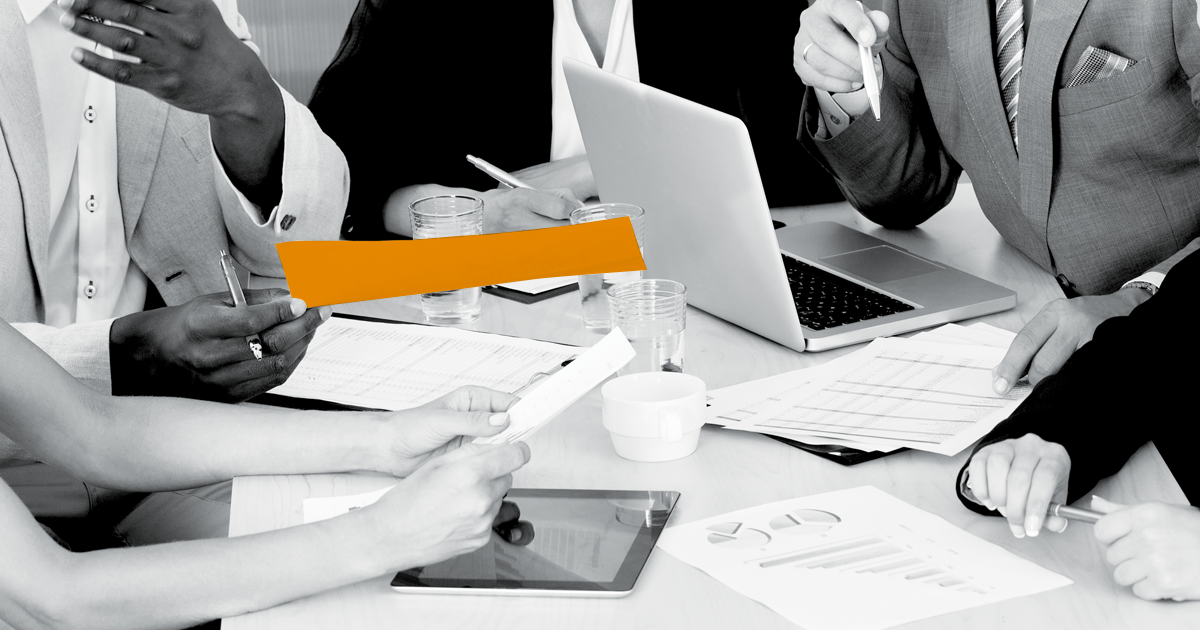 Image of group discussing a highlighted document