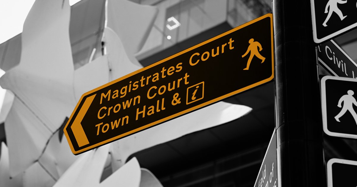 Image of a street sign showing the way to Magistrates Court