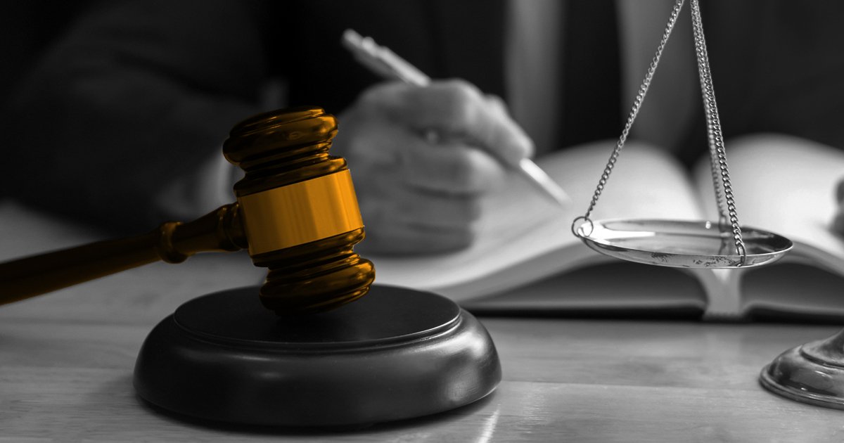 Highligted in orange shading a judges gavel bening struck on block