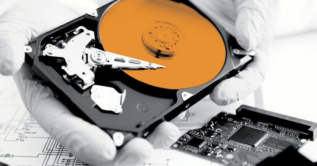 Image showing a person holding a hard rive that has been deconstructed.