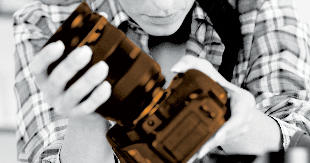 Image of a person holding and inspecting a camera.
